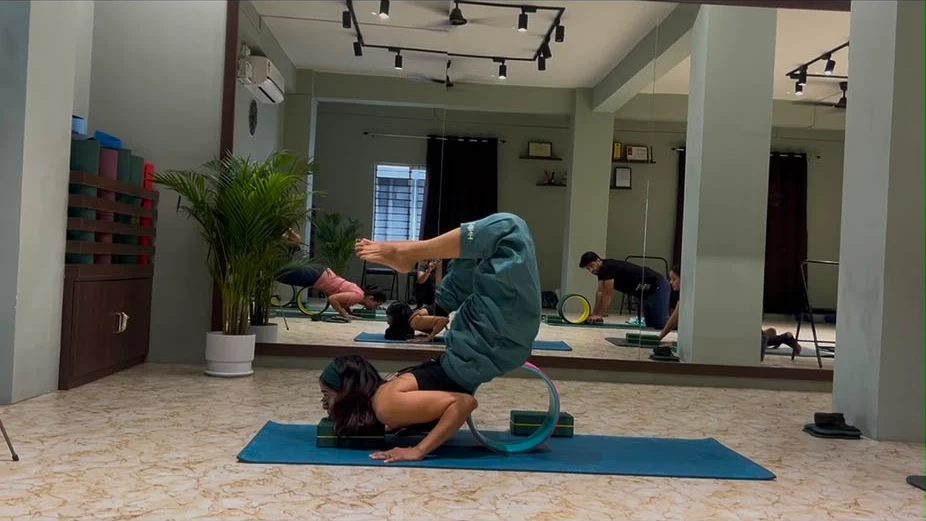 Advanced backbend practice on a yoga wheel at Paathway2Yoga studio in Ulubari, Guwahati